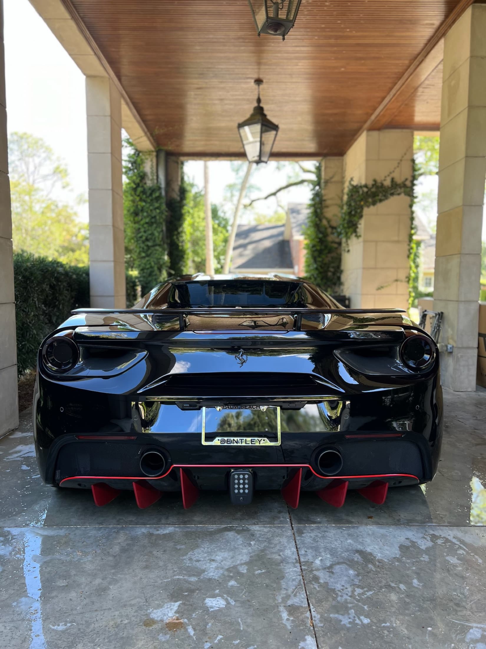 The rear of a black Ferrari after a Next Level detail